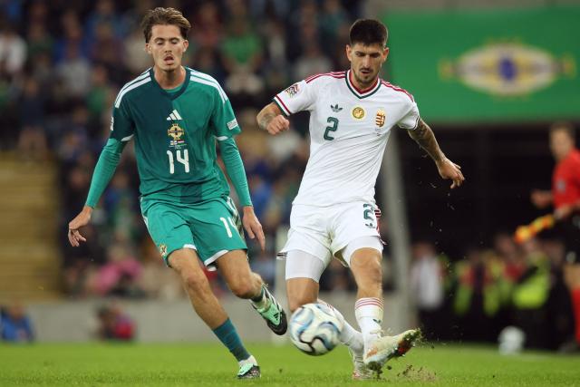 Hungary's defender #02 Attila Osvath (R) passes the ball during the UEFA Nations League, League B, Group 2 match between Northern Ireland and Hungary at Windsor Park in Belfast, Northern Ireland on September 28, 2026. (Photo by Paul Faith / AFP)