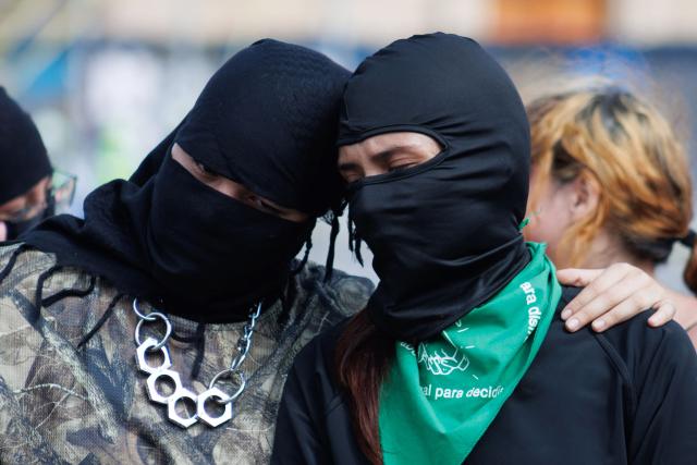 A couple of demonstrators hug as they take part in a demonstration in favor of the decriminalization of abortion on the occasion of the International Safe Abortion Day in Mexico City on September 28, 2025. (Photo by Franyeli Garcia / AFP)