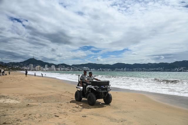 National Guard members patrol a beach in the tourist resort city of Acapulco, Guerrero state, Mexico, on September 28, 2026, while warning visitors to stay away from the shoreline due to high waves caused by Tropical Storm Rachel. (Photo by Francisco  ROBLES / AFP)