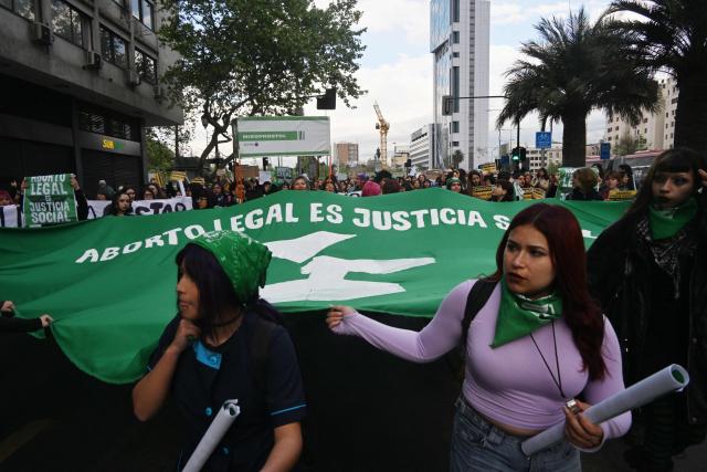 Women display a giant banner that reads in Spanish, "Legal abortion is social justice," during a demonstration in favor of the decriminalization of abortion on the occasion of the International Safe Abortion Day in Santiago on September 28, 2026. (Photo by RODRIGO ARANGUA / AFP)