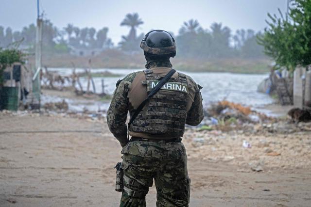 A member of the Mexican Navy stands near a flooded area in Puerto San Carlos, Baja California Sur state, Mexico, on September 28, 2026, ahead of the arrival of Hurricane Polo. Strong winds battered Mexico's Baja California peninsula on September 28 ahead of the arrival of Hurricane Polo, a major El Nino-charged storm that is expected to cause severe damage on the Pacific coast. (Photo by Carl de Souza / AFP)