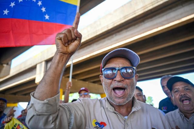 Workers and trade union members from Guayana's basic industries block access to industrial plants during a protest demanding the restoration of labour rights, free elections, the release of political prisoners and the return of opposition leader Maria Corina Machado in Puerto Ordaz, Bolivar state, Venezuela, on September 28, 2026. (Photo by Maryorin Mendez / AFP)