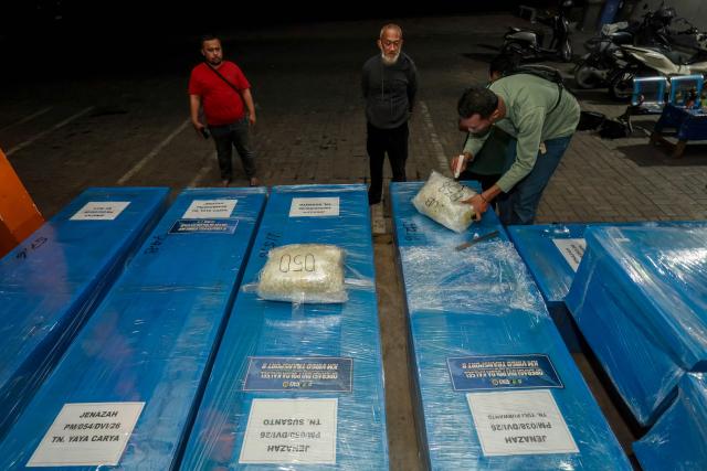 Coffins containing the identified remains of victims from the Virgo 8 ship disaster are prepared for repatriation to their respective hometowns at Syamsudin Noor Airport in Banjarbaru, South Kalimantan province, Indonesia on September 28, 2026. Dozens of victims identified by the South Kalimantan Regional Police Disaster Victim Identification (DVI) team are being returned to their families. (Photo by MUDA SAGALA / AFP)