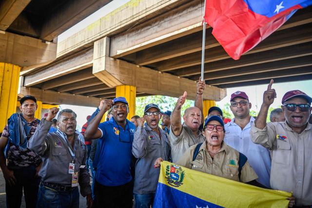 Workers and trade union members from Guayana's basic industries block access to industrial plants during a protest demanding the restoration of labour rights, free elections, the release of political prisoners and the return of opposition leader Maria Corina Machado in Puerto Ordaz, Bolivar state, Venezuela, on September 28, 2026. (Photo by Maryorin Mendez / AFP)