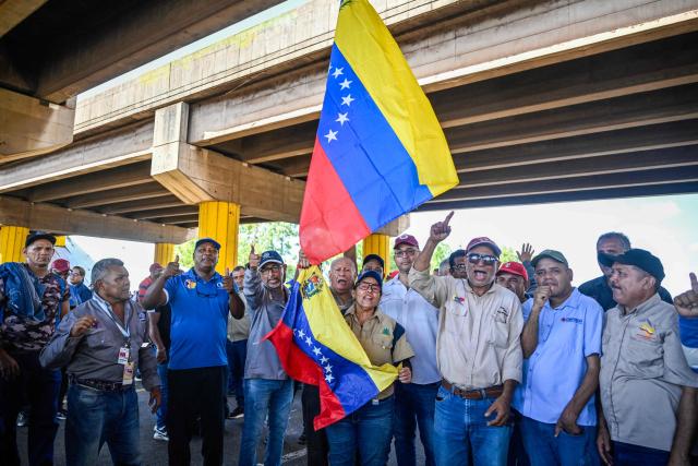 Workers and trade union members from Guayana's basic industries block access to industrial plants during a protest demanding the restoration of labour rights, free elections, the release of political prisoners and the return of opposition leader Maria Corina Machado in Puerto Ordaz, Bolivar state, Venezuela, on September 28, 2026. (Photo by Maryorin Mendez / AFP)