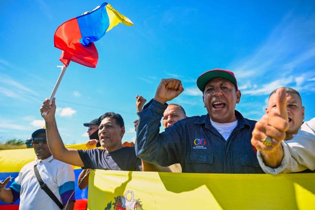 Workers and trade union members from Guayana's basic industries block access to industrial plants during a protest demanding the restoration of labour rights, free elections, the release of political prisoners and the return of opposition leader Maria Corina Machado in Puerto Ordaz, Bolivar state, Venezuela, on September 28, 2026. (Photo by Maryorin Mendez / AFP)
