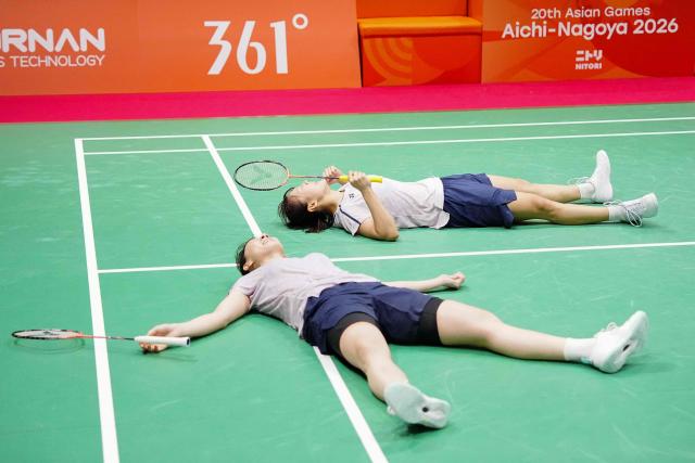 South Korea's Lee So-hee and Baek Ha-na celebrate their victory against China's Liu Shengshu and Tan Ning during the women's doubles badminton final during the 2026 Asian Games at the Ichinomiya City Municipal Gymnasium in Ichinomiya, Aichi prefecture on September 29, 2026. (Photo by Yuichi YAMAZAKI / AFP)