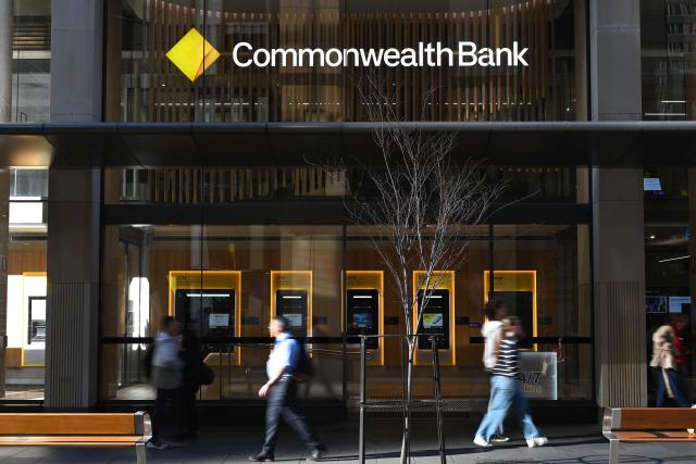Pedestrians walk past a Commonwealth Bank branch in Sydney's central business district on September 29, 2026. Australia's central bank raised the key interest rate to a 15-year high on September 29 to curb inflation, which the government blamed on the prolonged war in the Middle East. The Reserve Bank of Australia lifted its cash rate 25 basis points to 4.6 percent, it said, citing a broadening conflict in the Middle East and high global energy prices. (Photo by Saeed KHAN / AFP)