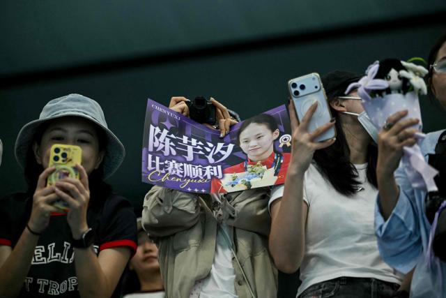 Supporters of gold medallist China's Chen Yuxi takes pictures of her following the victory ceremony of the women's 10m platform final diving event during the 2026 Asian Games at the Tokyo Aquatics Centre in Tokyo on September 29, 2026. (Photo by ANDREW CABALLERO-REYNOLDS / AFP)