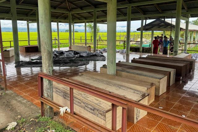 EDITORS NOTE: Graphic content / Wooden coffins are lined up inside a shelter as relatives gather to identify the bodies of their loved ones following a military airstrike the previous day in Kyauktaw town, Rakhine State on September 29, 2026. The death toll from a military airstrike in west Myanmar rose to 50 on September 29, two local aid workers at the scene said, the day after it struck a busy market. (Photo by AFP)