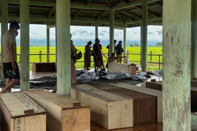 EDITORS NOTE: Graphic content / Wooden coffins are lined up inside a shelter as relatives gather to identify the bodies of their loved ones following a military airstrike the previous day in Kyauktaw town, Rakhine State on September 29, 2026. The death toll from a military airstrike in west Myanmar rose to 50 on September 29, two local aid workers at the scene said, the day after it struck a busy market. (Photo by AFP)
