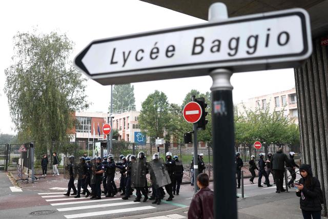 French national police in anti-riot gear take position as students carry out a blocking protest at the Cesar Baggio secondary school during a day of nationwide public sector strikes and demonstrations, in Lille, on September 29, 2026. Public sector workers, including firefighters, hold a one-day strike and demonstrations across France on September 29 in response to a call from a broad inter-union coalition, with the aim of putting pressure on the government two days before the presentation of the draft budget for 2027. (Photo by Sameer AL-DOUMY / AFP)
