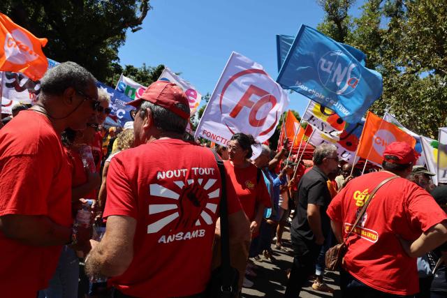 Protesters hold trade union flags as they take part in a rally during a day of nationwide public sector strikes and demonstrations, in Saint-Denis, French Indian Ocean island of La Reunion, on September 29, 2026. Public sector workers, including firefighters, hold a one-day strike and demonstrations across France on September 29 in response to a call from a broad inter-union coalition, with the aim of putting pressure on the government two days before the presentation of the draft budget for 2027. (Photo by Richard BOUHET / AFP)