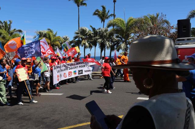 Protesters hold trade union flags as they take part in a rally during a day of nationwide public sector strikes and demonstrations, in Saint-Denis, French Indian Ocean island of La Reunion, on September 29, 2026. Public sector workers, including firefighters, hold a one-day strike and demonstrations across France on September 29 in response to a call from a broad inter-union coalition, with the aim of putting pressure on the government two days before the presentation of the draft budget for 2027. (Photo by Richard BOUHET / AFP)