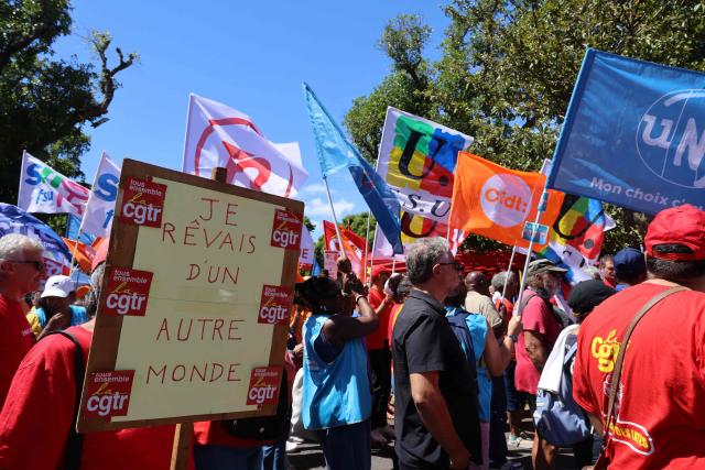 Protesters hold trade union flags as they take part in a rally during a day of nationwide public sector strikes and demonstrations, in Saint-Denis, French Indian Ocean island of La Reunion, on September 29, 2026. Public sector workers, including firefighters, hold a one-day strike and demonstrations across France on September 29 in response to a call from a broad inter-union coalition, with the aim of putting pressure on the government two days before the presentation of the draft budget for 2027. (Photo by Richard BOUHET / AFP)