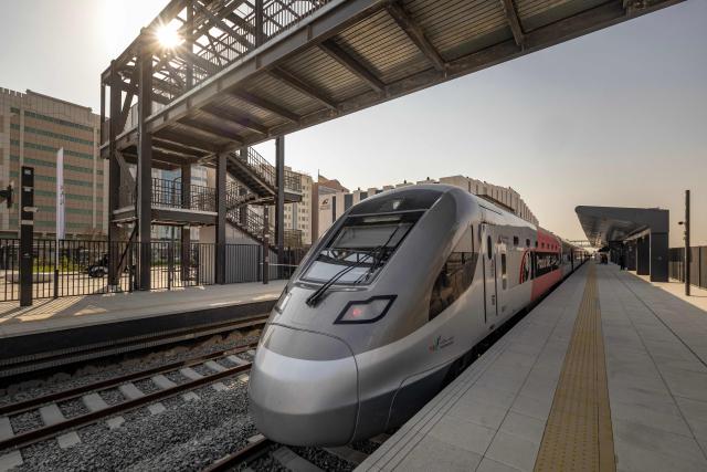 CORRECTION / An Etihad Rail train arrives on September 29, 2026, during the inaugural passenger service connecting from Abu Dhabi's Mohamed Bin Zayed City station to Dubai's Yalayis station. (Photo by FADEL SENNA / AFP) / “The erroneous mention[s] appearing in the metadata of this photo by FADEL SENNA has been modified in AFP systems in the following manner: [TO DUBAI'S] instead of [AT DUBAI'S]. Please immediately remove the erroneous mention[s] from all your online services and delete it (them) from your servers. If you have been authorized by AFP to distribute it (them) to third parties, please ensure that the same actions are carried out by them. Failure to promptly comply with these instructions will entail liability on your part for any continued or post notification usage. Therefore we thank you very much for all your attention and prompt action. We are sorry for the inconvenience this notification may cause and remain at your disposal for any further information you may require.”