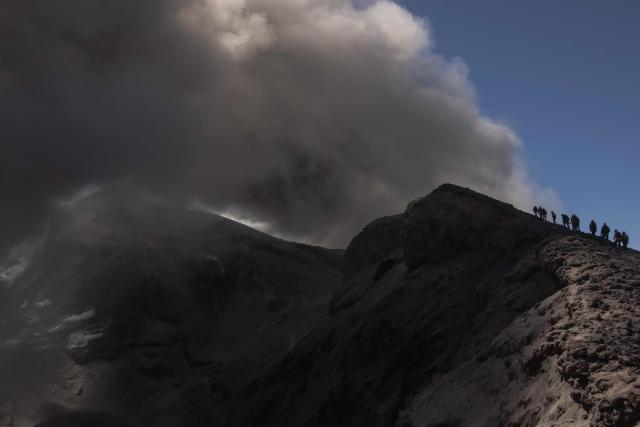 Visitors climb Mount Etna as smoke rises from its volcano in Catania, on the Mediterranean island of Sicily, on September 28, 2026. (Photo by Roman PILIPEY / AFP)
