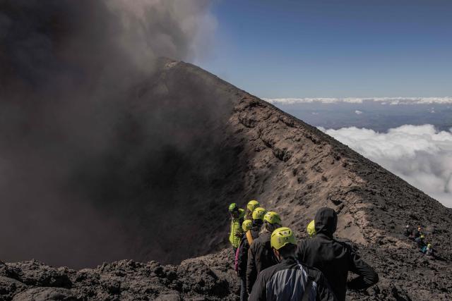 Visitors climb Mount Etna as smoke rises from its volcano in Catania, on the Mediterranean island of Sicily, on September 28, 2026. (Photo by Roman PILIPEY / AFP)