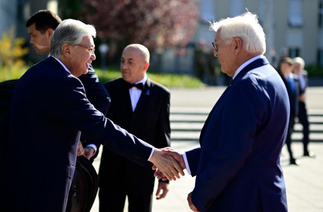 German President Frank-Walter Steinmeier (R) shakes hands with Kazakhstan's President Kassym-Jomart Tokayev as he arrives for a welcome ceremony at the German Defence Ministry in Berlin on September 29, 2026. (Photo by Tobias SCHWARZ / AFP)