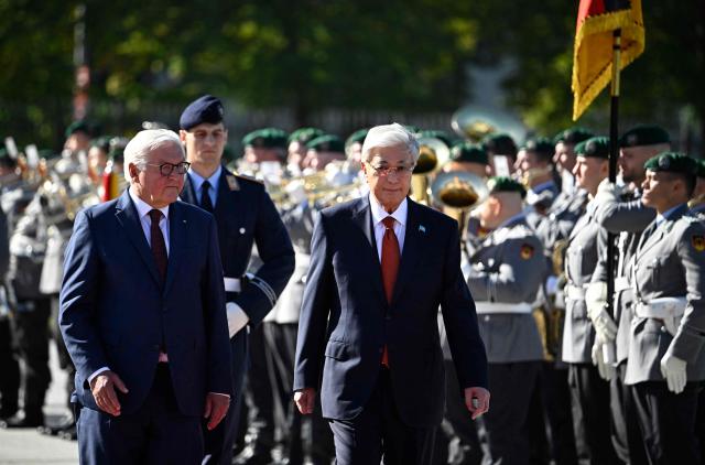 German President Frank-Walter Steinmeier (L) and Kazakhstan's President Kassym-Jomart Tokayev review a military honor guard during a welcome ceremony at the German Defence Ministry in Berlin on September 29, 2026. (Photo by Tobias SCHWARZ / AFP)