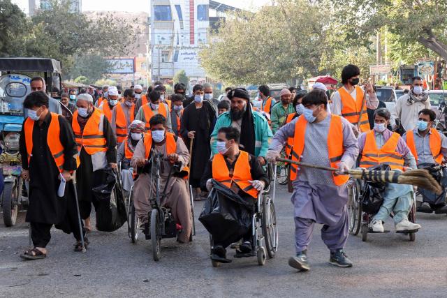 Afghan men with disabilities participate in a symbolic clean-up drive in Afghanistan's Herat city on September 29, 2026. (Photo by Mohsen KARIMI / AFP)