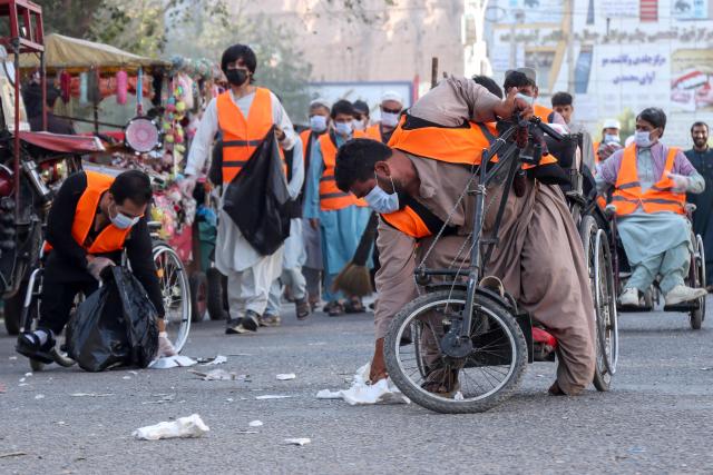 Afghan men with disabilities participate in a symbolic clean-up drive in Afghanistan's Herat city on September 29, 2026. (Photo by Mohsen KARIMI / AFP)