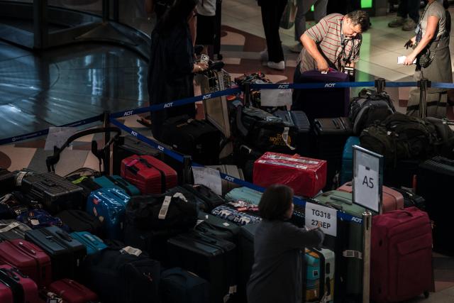 Passenger's baggage from Thai Airways flights is seen at Suvarnabhumi International Airport in Bangkok on September 29, 2026, after flooding disrupted the airline's ground services. More than 500,000 households and 1.7 million people across 27 provinces have been impacted by floods in Thailand after an intense weather system hit the region, the government said. (Photo by AFP)