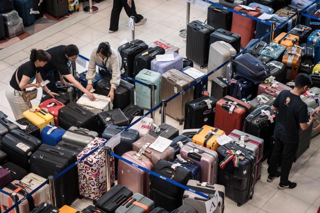 Passenger's baggage from Thai Airways flights is seen at Suvarnabhumi International Airport in Bangkok on September 29, 2026, after flooding disrupted the airline's ground services. More than 500,000 households and 1.7 million people across 27 provinces have been impacted by floods in Thailand after an intense weather system hit the region, the government said. (Photo by AFP)