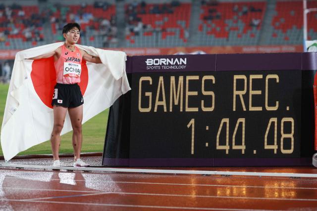 Japan's Ko Ochiai celebrates after setting a games record in the men's 800m final during the 2026 Asian Games at Nagoya City Mizuho Park Athletic Stadium in Nagoya, Aichi Prefecture on September 29, 2026. (Photo by DAVID GRAY / AFP)