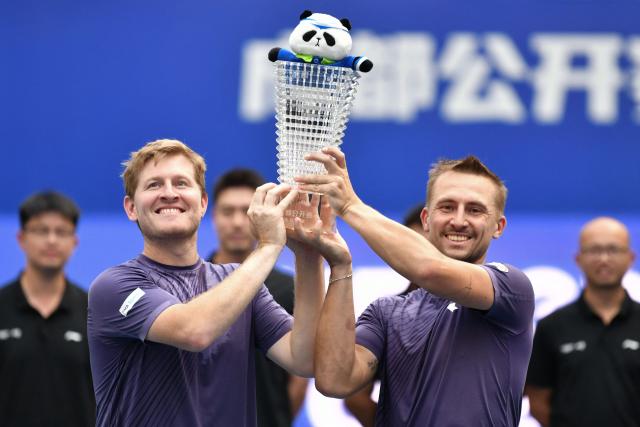 Britain’s Luke Johnson (L) and Poland’s Jan Zielinski (R) celebrate with the trophy after beating USA’s Robert Galloway and Sweden’s Andre Goransson in the men’s doubles final at the Chengdu Open tennis tournament in Chengdu, in China’s southwest Sichuan province on September 29, 2026. (Photo by AFP) / China OUT