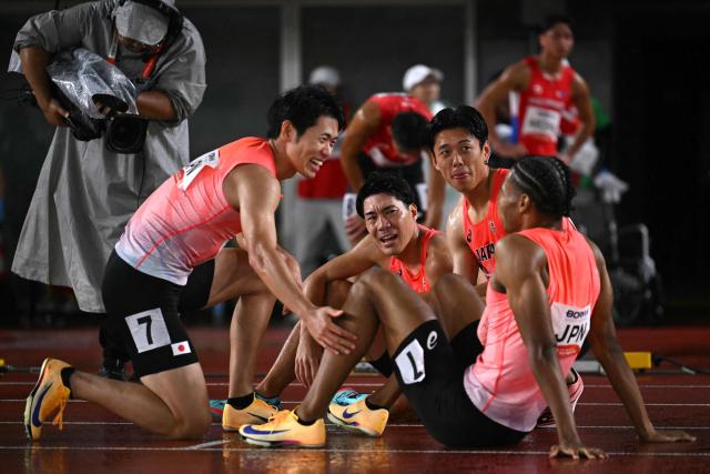 Japan's Fuga Sato, Japan's Shinya Hayashi, Japan's Kenki Imaizumi and Japan's Yuki Joseph Nakajima celebrate winning the men's 4x400m relay final during the 2026 Asian Games at Nagoya City Mizuho Park Athletic Stadium in Nagoya, Aichi Prefecture on September 29, 2026. (Photo by MOHD RASFAN / AFP)