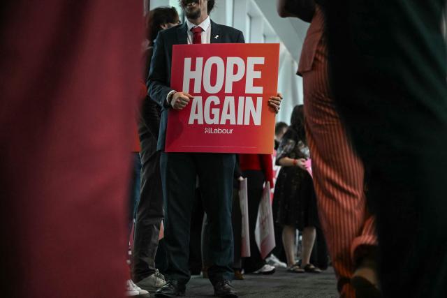 A supporter holds a 'Hope Again' sign before the arrival of Britain's Prime Minister Andy Burnham on the third day of the annual Labour Party conference in Liverpool, north-west England, on September 29, 2026. (Photo by Paul ELLIS / AFP)