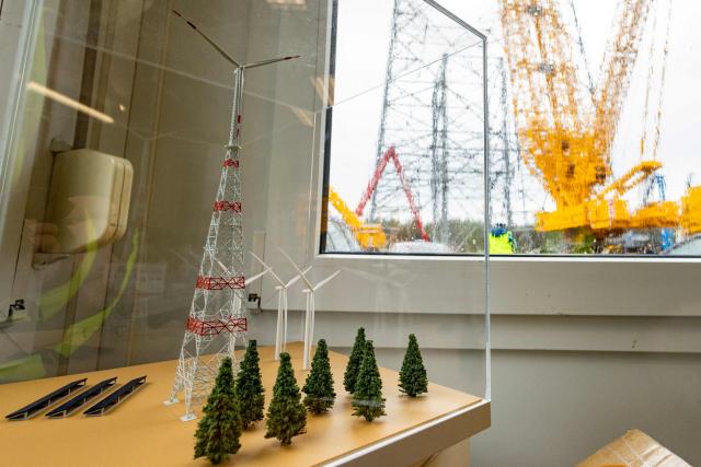 (FILES) A model of the world's tallest wind turbine is seen at the construction's building site in Schipkau, eastern Germany on May 13, 2026. The giant structure in the former coal-mining region of Lusetia in Brandenburg state -- dwarfing the Eiffel Tower at 365 metres -- was completed on September 28, 2026. Once its huge rotor blades start spinning in the steady high-altitude winds, it is expected to generate enough electricity to power 7,500 households. (Photo by Odd ANDERSEN / AFP)