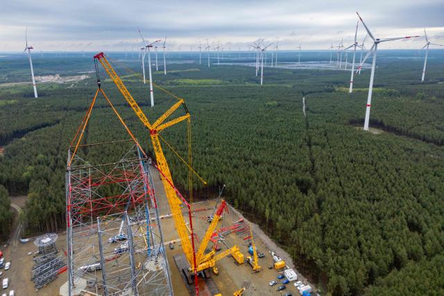 (FILES) Aerial view taken on May 13, 2026 shows construction workers 100 meters up as they put together what became the world's tallest wind turbine in Schipkau, eastern Germany. The giant structure in the former coal-mining region of Lusetia in Brandenburg state -- dwarfing the Eiffel Tower at 365 metres -- was completed on September 28, 2026. Once its huge rotor blades start spinning in the steady high-altitude winds, it is expected to generate enough electricity to power 7,500 households. (Photo by Odd ANDERSEN / AFP)