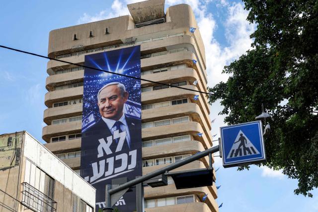A giant electoral poster for Israeli Prime Minister Benjamin Netanyahu's Likud party with the slogan "no surrender" is displayed on the facade of a building in Tel Aviv on September 29, 2026 during campaigns ahead of the October 2026 legislative elections. (Photo by Jack GUEZ / AFP)