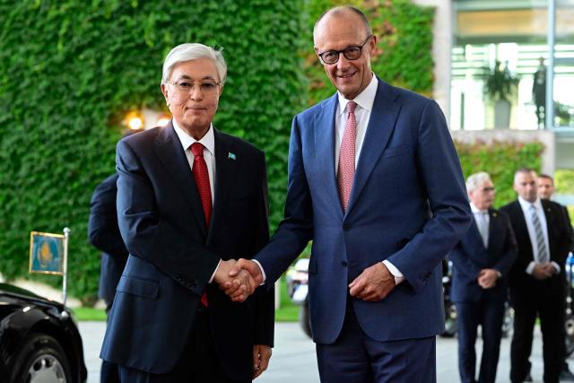 German Chancellor Friedrich Merz (R) shakes hands with Kazakhstan's President Kassym-Jomart Tokayev as he arrives for a visit at the Chancellery in Berlin on September 29, 2026. (Photo by John MACDOUGALL / AFP)
