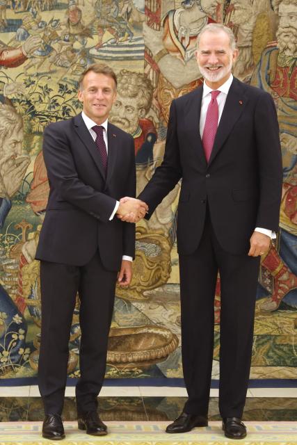 Spain's King Felipe VI shakes hands with France's President Emmanuel Macron (L) prior a meeting at Madrid's Zarzuela Palace on September 29, 2026. French President Emmanuel Macron is on a two-day official visit in Spain. (Photo by Ludovic MARIN / AFP)