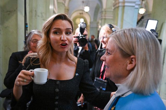 Christian Democrats leader Ebba Busch (L) drinks a cup of coffee as she speaks to Social Democratic Party leader Magdalena Andersson (R) prior to giving an interview after the opening of the Swedish Parliament Riksdagen on September 29, 2026 in Stockholm, as the parliament meets for the first plenary session after the general elections. (Photo by Jonathan NACKSTRAND / AFP)