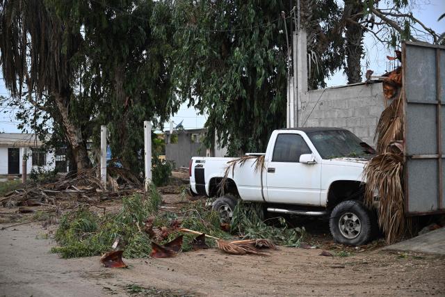 A damaged pickup truck is pictured following the arrival of Hurricane Polo in the flooded town of Puerto San Carlos, Baja California Sur, Mexico, on September 29, 2026. Strong winds battered Mexico's Baja California peninsula on September 28 ahead of the arrival of Hurricane Polo, a major El Nino-charged storm that is expected to cause severe damage on the Pacific coast. (Photo by Carl de Souza / AFP)