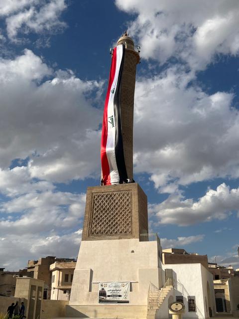 A giant Iraqi flag hangs off the reconstructed 12th century "Hadba" leaning minaret at the historic Great Mosque of al-Nuri in the old city of Mosul on September 29, 2026 as Iraq marks the withdrawal of the US-led anti-Islamic State coalition forces from the country. After more than a decade, the US-led coalition is ending its mission in Iraq, having helped save the country from jihadists but causing persistent friction in the country. Baghdad and Washington agreed in 2024 to wind down the coalition's mission, and its troops withdrew gradually from bases across the country, restricting their presence to the autonomous northern Kurdistan region. Iraqi Prime Minister Ali al-Zaidi declared that October 1, the day following the coalition's departure, should be celebrated as Sovereignty Day. (Photo by Zaid AL-OBEIDI / AFP)