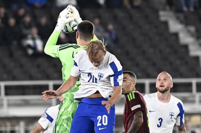 Belarus' goalkeeper #21 Fedor Lapoukhov makes a save over Finland's forward #20 Joel Pohjanpalo during the UEFA Nations League - League C, Group 1 - day 2 football match between Finland and Belarus at the Helsinki Olympic Stadium in Helsinki, Finland, on September 29, 2026. (Photo by Roni Rekomaa / Lehtikuva / AFP) / Finland OUT