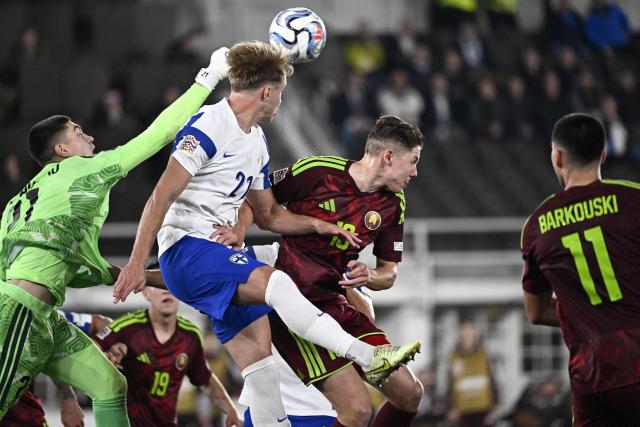 Belarus' goalkeeper #21 Fedor Lapoukhov makes a save over Finland's defender #21 Ville Koski during the UEFA Nations League - League C, Group 1 - day 2 football match between Finland and Belarus at the Helsinki Olympic Stadium in Helsinki, Finland, on September 29, 2026. (Photo by Roni Rekomaa / Lehtikuva / AFP) / Finland OUT
