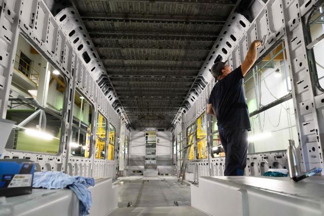 A worker paints inside a CAF (Construcciones y Auxiliar de Ferrocarriles) Regiolis train at the Spanish railway manufacturer CAF's factory during a press visit, in Reichshoffen, eastern France, on September 29, 2026. (Photo by SEBASTIEN BOZON / AFP)