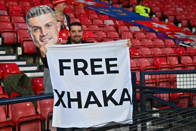 A fan of Switzerland's midfielder Granit Xhaka hlds up a banner in the crowd ahead of the UEFA Nations League, League B, Group 1 match football match between Scotland and Switzerland at Hampden Park in Glasgow, Scotland on September 29, 2026.  (Photo by ANDY BUCHANAN / AFP)