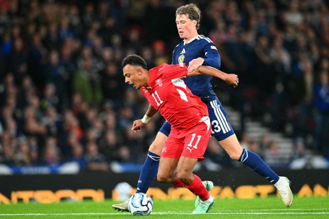 Scotland's defender #13 Jack Hendry (R) pulls back Switzerland's midfielder #11 Dan Ndoye (R) and is sent off during the UEFA Nations League, League B, Group 1 match football match between Scotland and Switzerland at Hampden Park in Glasgow, Scotland on September 29, 2026.  (Photo by ANDY BUCHANAN / AFP)