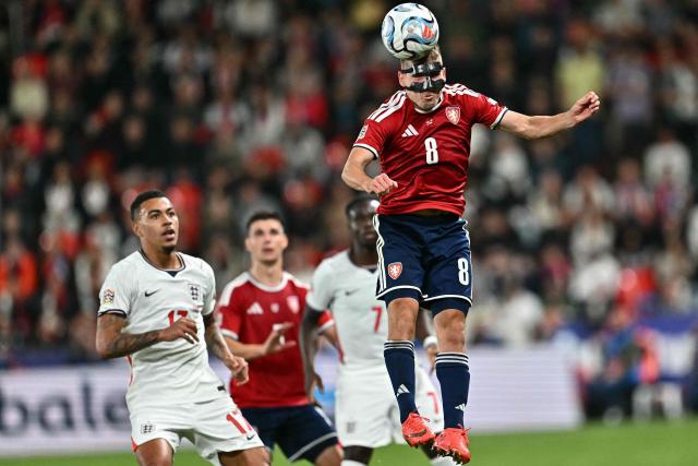 Czech Republic's midfielder #08 Michal Sadilek (R) gets up to head the ball next to England striker #17 Morgan Rogers (L) during the UEFA Nations League Group A3 football match between the Czech Republic and England at Fortuna Arena in Prague on September 29, 2026. (Photo by Joe Klamar / AFP)