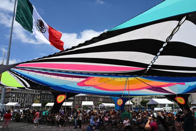 Attendees take part in cultural activities during the National Corn Day commemoration in Mexico City's Zocalo Square on September 29, 2026. The Mexican government, together with farmers, peasant organisations and civil society groups, is showcasing products derived from Mexico's 64 native maize varieties, considered a symbol of national identity and cultural heritage. (Photo by Yuri CORTEZ / AFP)