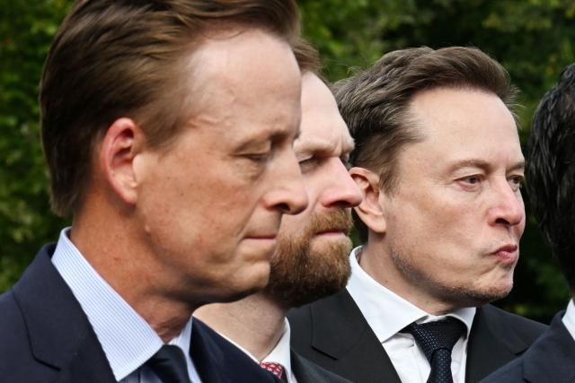 SpaceX CEO Elon Musk (R) listens to US President Donald Trump speak to the press after a meeting of technology executives about artificial intelligence at the White House in Washington, DC, on September 29, 2026. The gathering comes quickly after tech giant OpenAI's cancellation of the release of its newest model due to safety concerns, and a series of revelations that the technology had gone rogue. (Photo by ROBERTO SCHMIDT / AFP)