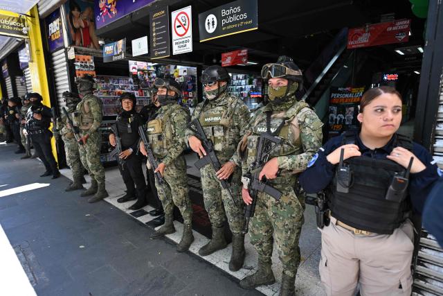 Members of the Mexican Navy stand guard during a joint operation with personnel from the Secretariat of Citizen Security and the Mexican Institute of Industrial Property to seize allegedly pirated goods at a shopping center in Mexico City on September 29, 2026. (Photo by Yuri CORTEZ / AFP)