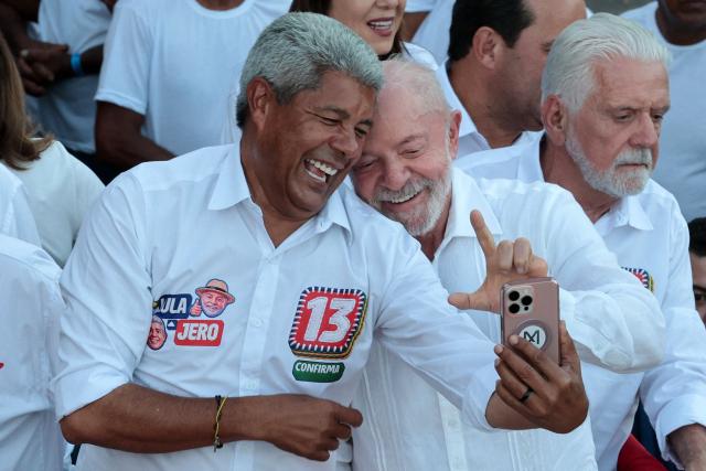 Brazil's President and presidential candidate Luiz Inacio Lula da Silva (R) and the governor of Bahia Jeronimo Rodrigues pose for a selfie during a campaign rally in Salvador, Bahia state, Brazil on September 29, 2026. Brazil will hold presidential election on October 4, 2026. (Photo by ANTONELLO VENERI / AFP)